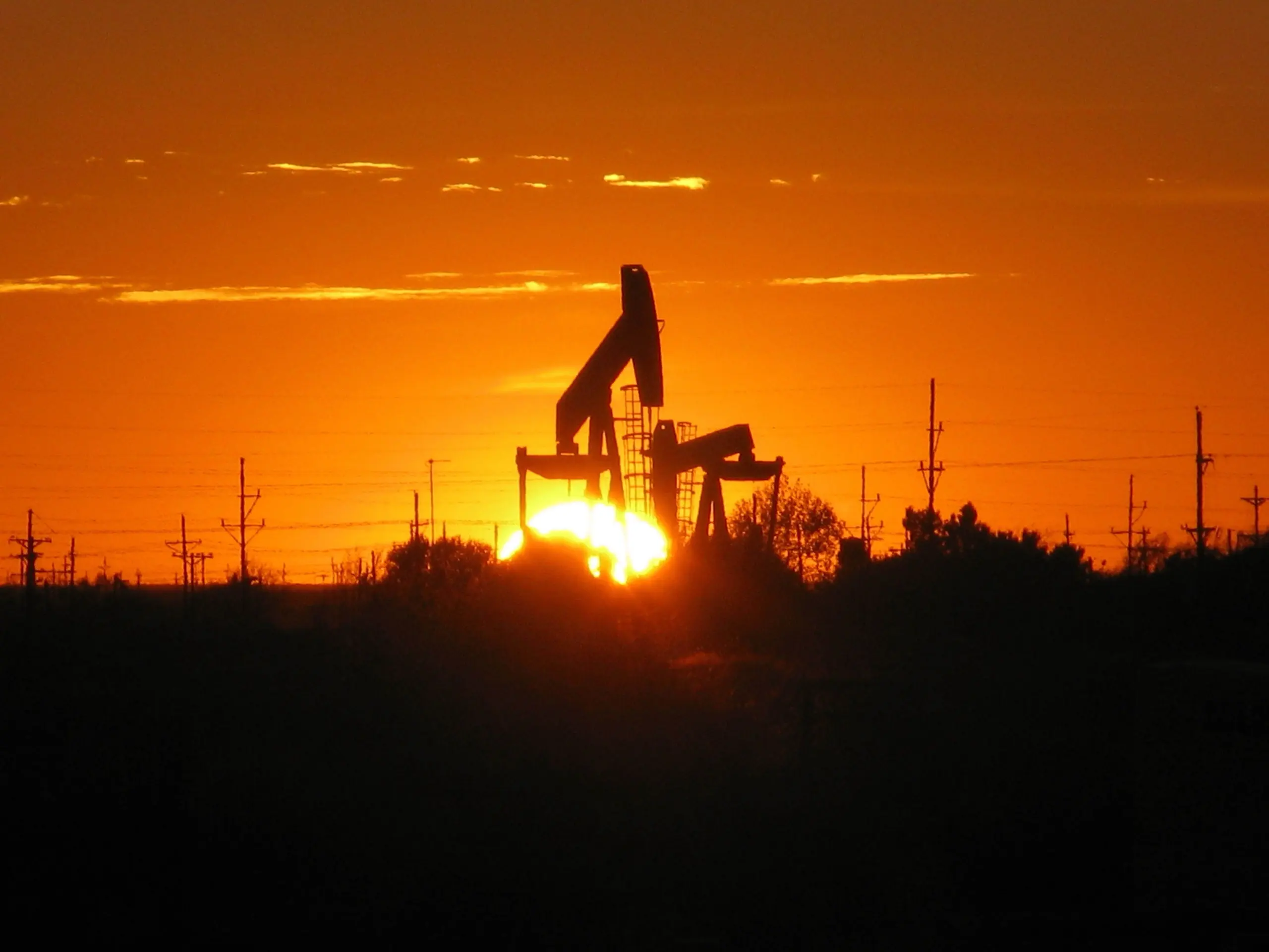 Sell mineral rights: pumpjacks silhouetted against the setting sun near Midland, Texas